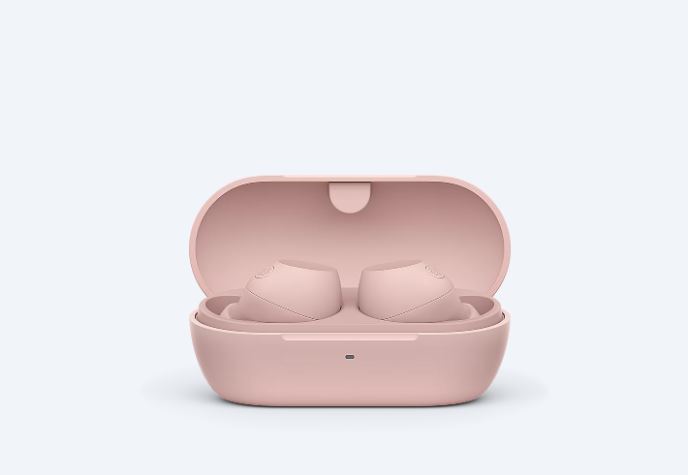 Pink Sony WF-C710N wireless earbuds placed inside an open charging case
