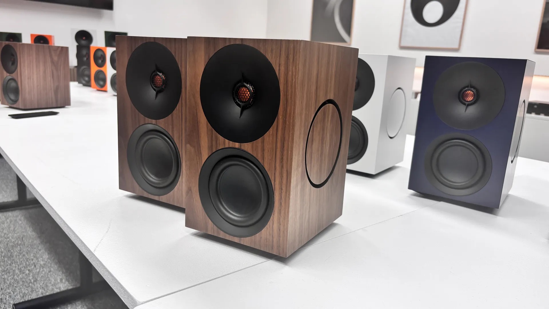 Bookshelf speakers placed on stands in a living room stereo listening setup.

