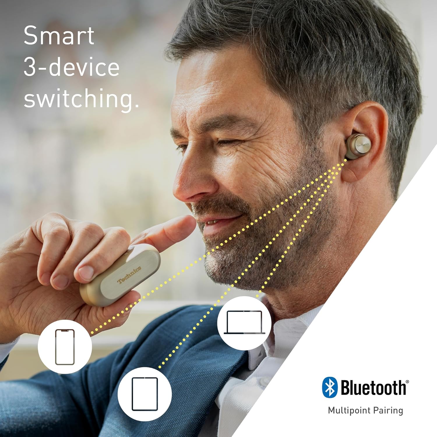 Man wearing Technics wireless earbuds demonstrating smart 3-device switching with Bluetooth multipoint pairing